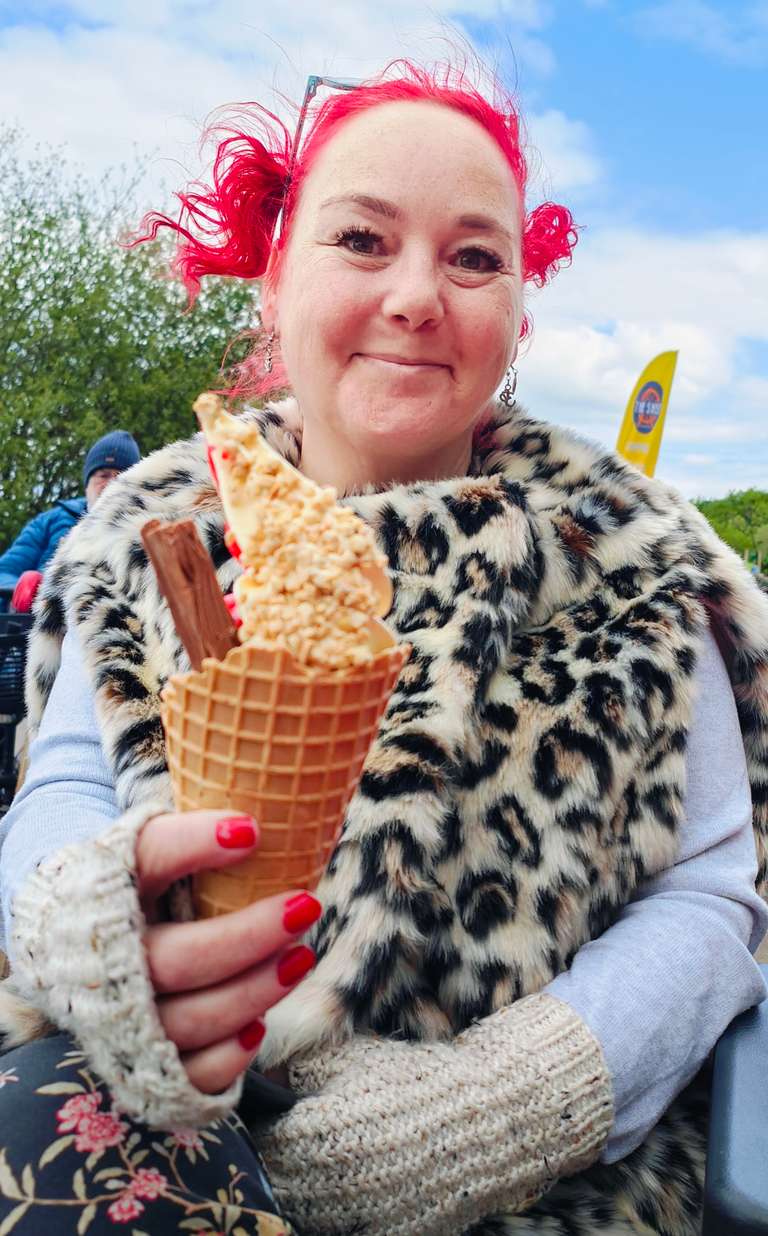Close-up of me with my ice cream at Chasewater, looking pleased as punch with my leopard print coat and knitted wristlets. The ice cream's got a proper Flake in it - none of your cheap knock-offs here! Sometimes the simple pleasures are the best, even when the British 'spring' weather demands winter clothes.