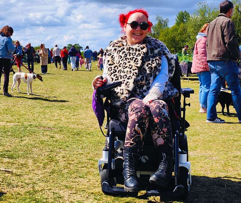 Close-up at the plant fair, sporting my round sunglasses and signature leopard print coat. The sun's made an appearance and I'm grinning from ear to ear - nothing beats a day out with plants, people and fresh air! My wheelchair giving me the freedom to enjoy days like this is something I'll never take for granted.